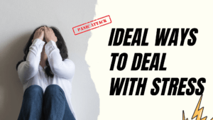 Stress management A girl in a white dress and blue jeans sitting in front of others with her face buried in her hands, portraying stress and emotional overwhelm.