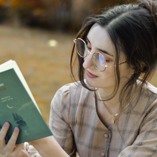 A beautiful girl reading a book in garden Showing the importance of self awareness